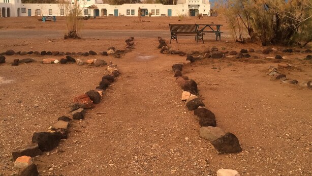 A gravel path leading to a white building with a sign reading "AMARGOSA OPERA HOUSE". - Amargosa Opera House (Death Valley)