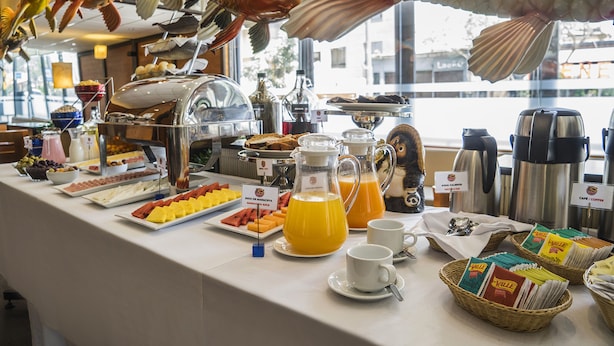 A buffet with various food items, including fruits, cheeses, and beverages. - Allpa Hotel & Suites (Lima)
