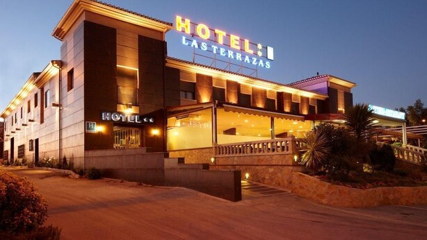 A hotel named "HOTEL LAS TERRAZAS" with a modern facade, large windows, and a well-lit entrance. - Hotel Las Terrazas (Albolote)