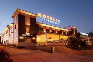 A hotel named "HOTEL LAS TERRAZAS" with a modern facade, large windows, and a well-lit entrance. - Hotel Las Terrazas (Albolote)