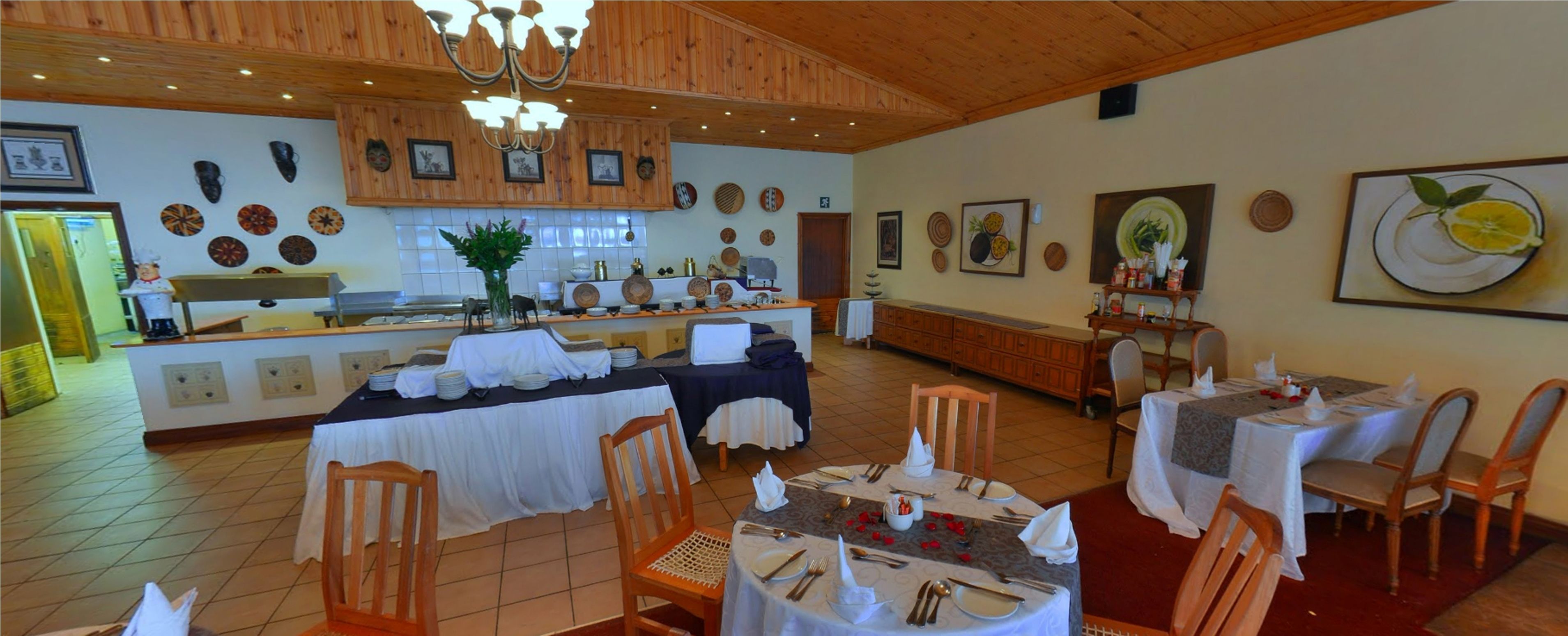 A restaurant with wooden interiors, a central bar area, and multiple dining tables set for guests.