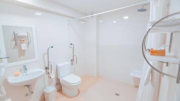 A modern bathroom with a sink, toilet, and shower.