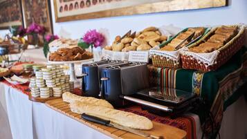 A buffet table with various food items and a toaster.