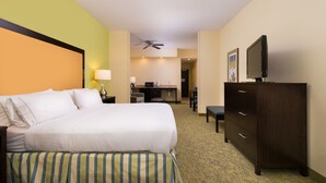 A hotel room with a bed, a desk, a chair, a television, and a ceiling fan. - Holiday Inn Express Hotel and Suites Scranton by IHG (Scranton)