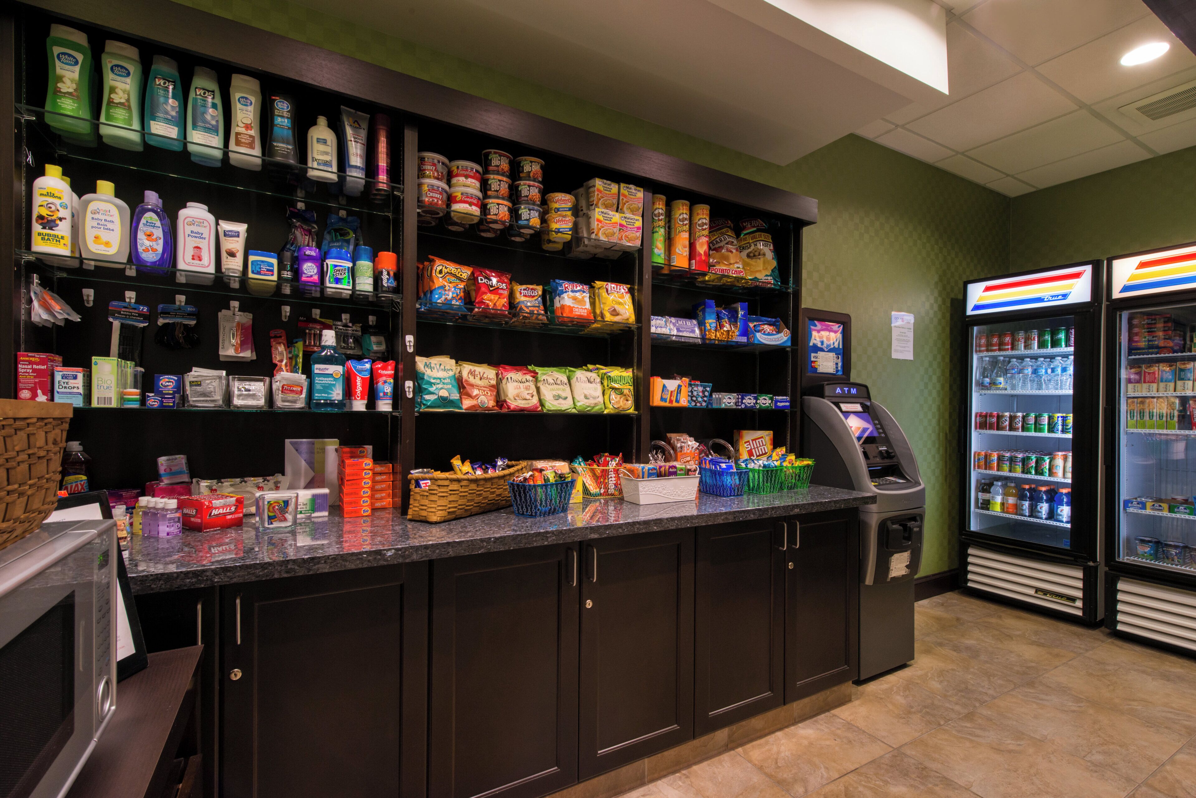A self-service kiosk with a variety of products including snacks, beverages, and toiletries.