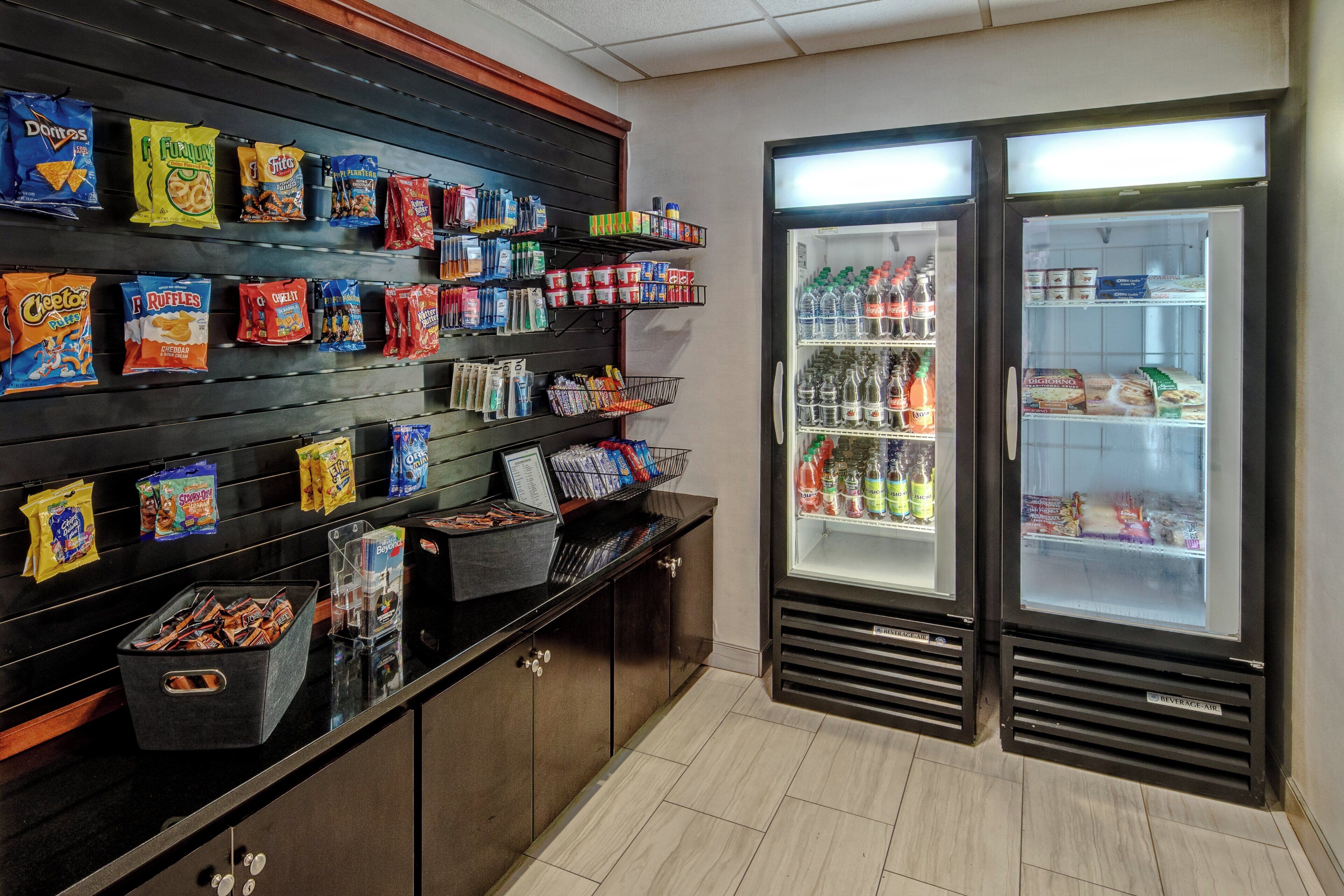 A snack display with various chips and a beverage refrigerator.