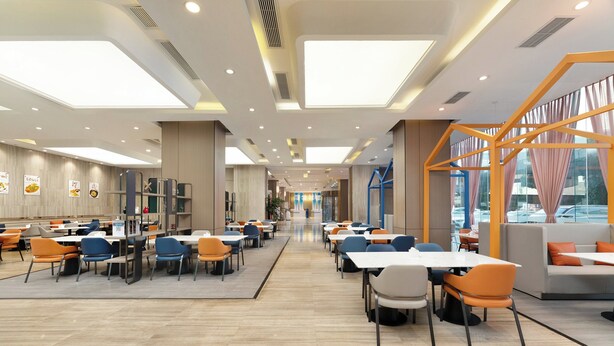 A spacious indoor dining area with high ceilings, recessed lighting, and large windows. - Holiday Inn Express Chengdu Wuhou by IHG (Chengdu)