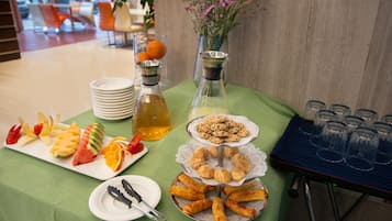 A buffet table with various food items and beverages.
