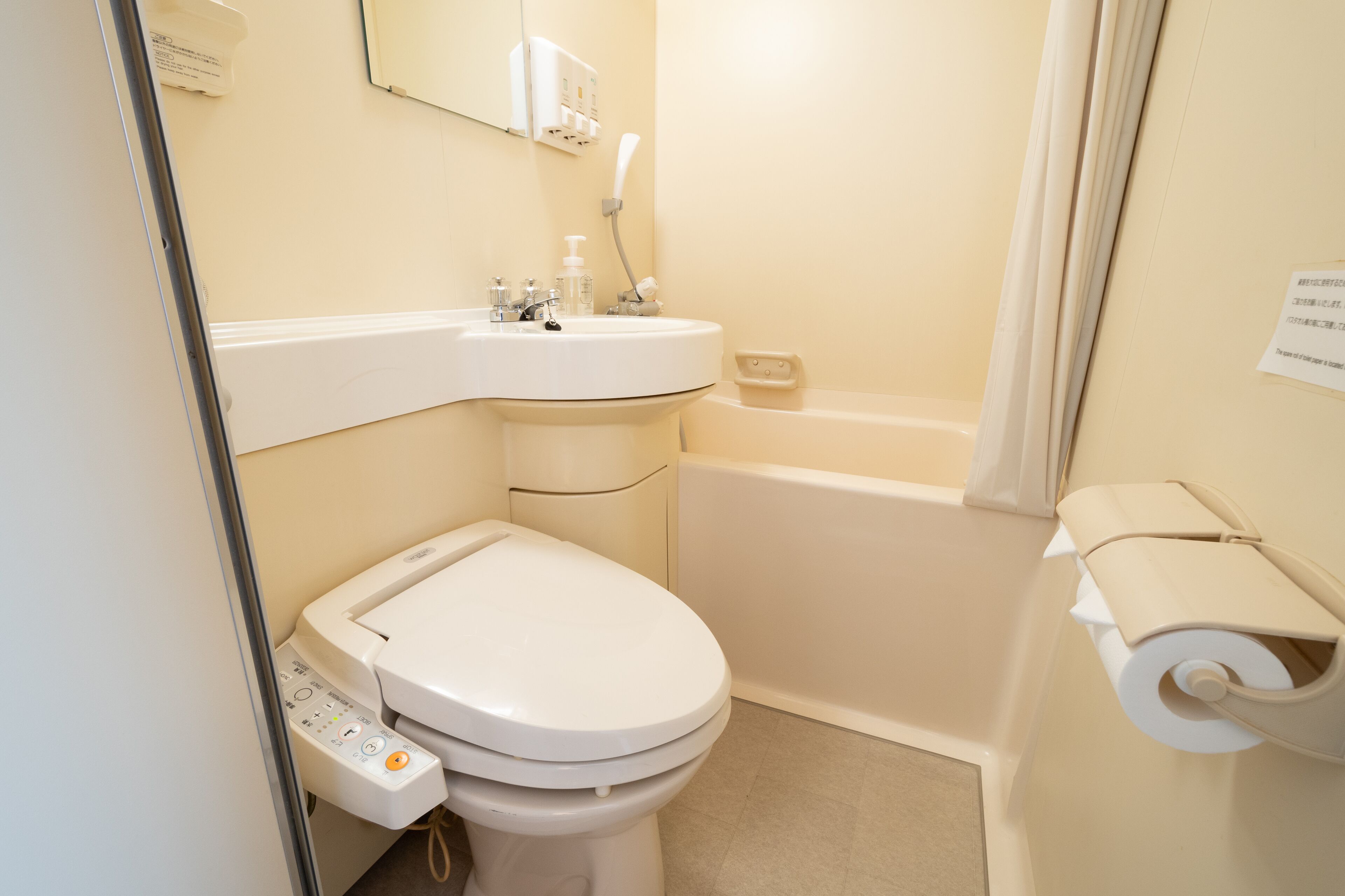 A bathroom with a toilet, sink, and bathtub.