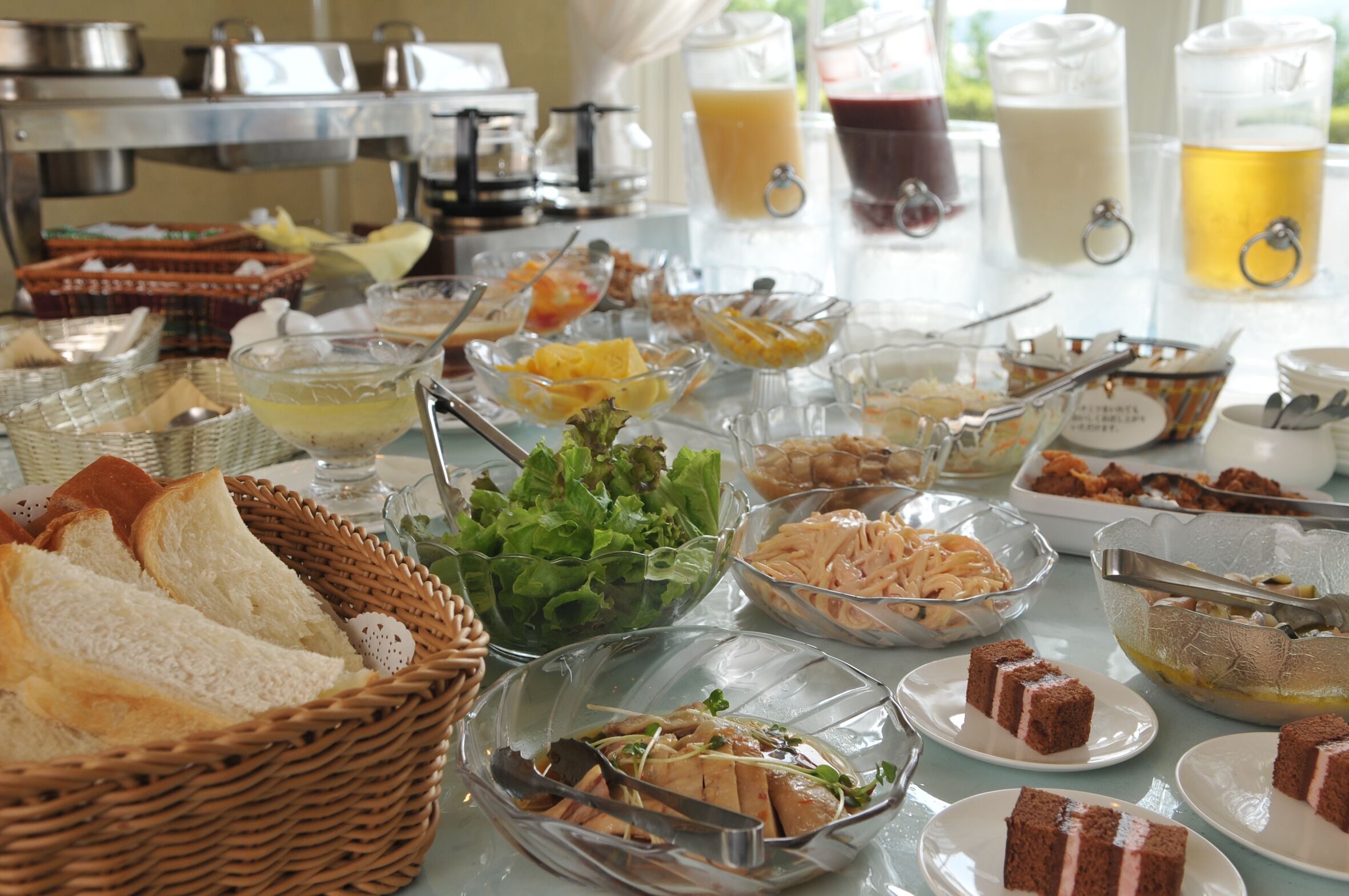 A buffet with various food items and beverages.