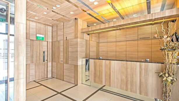 A modern elevator interior with wooden paneling and a glass door. - Hotel 81 Osaka (Singapore)