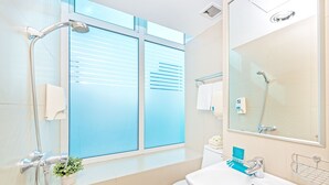 A modern bathroom with a shower, toilet, and sink. - Hotel 81 Bugis (Singapore)