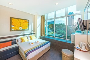 A hotel room with a large bed, a view of greenery outside, and a coffee station. - Hotel 81 Bugis (Singapore)