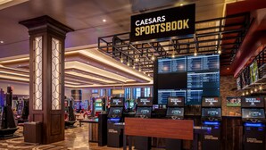 A Caesars Sportsbook area with multiple betting kiosks and a large digital display. - Horseshoe Lake Charles Hotel & Casino -  A Caesars Rewards Destination (Westlake)
