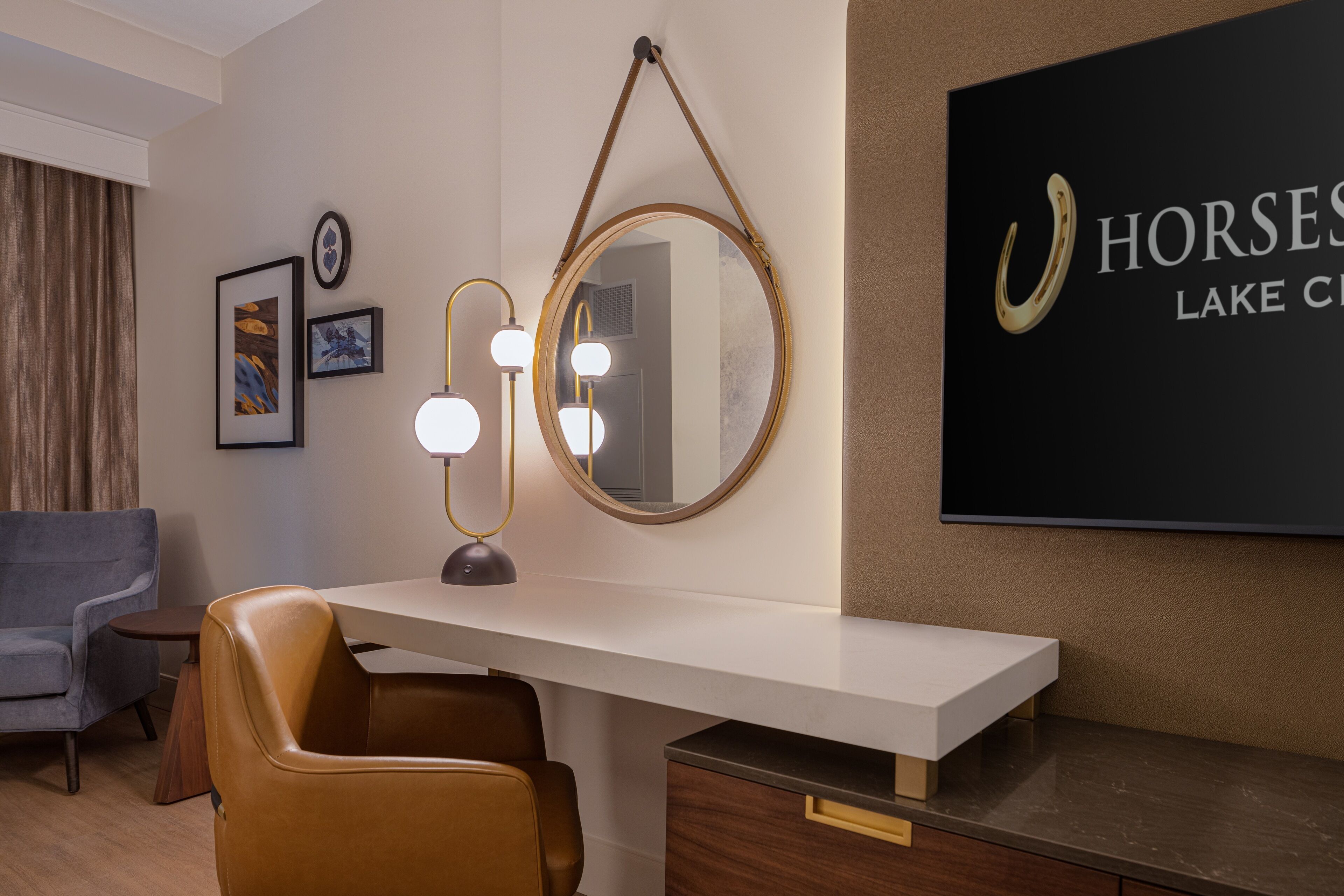 A modern room with a desk, a mirror, and a mounted sign.