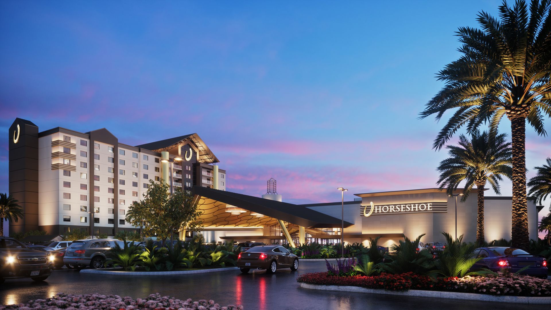 A hotel with a horseshoe-shaped entrance, a parking lot, and a horseshoe sign.