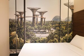 A hotel room with a large bed, a view of a botanical garden, and a mural of a modern building. - Days Inn by Wyndham Singapore Novena (Singapore)