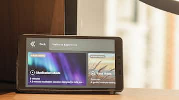A smartphone displaying a wellness app with meditation and rest modes.