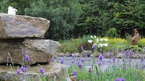 A garden with a rock feature, lavender, and a statue. - Abbeyleix Manor Hotel (Abbeyleix)