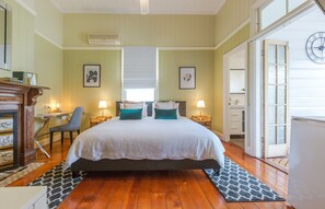 A bedroom with a bed, a desk, a chair, and a dresser. - 99 Kirkland Bed & Breakfast (Coorparoo)