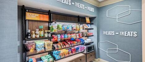 A snack display with various packaged foods and beverages.