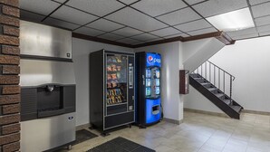 A vending machine area with a Pepsi machine and a snack vending machine, a staircase, and a fire extinguisher on the wall. - Motel 6 Warminster, PA (Warminster)