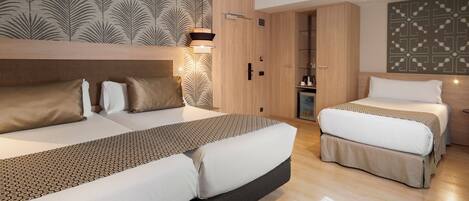 Ein modernes Hotelzimmer mit zwei Betten, einem Kleiderschrank, einem Schminktisch und einem Badezimmer.