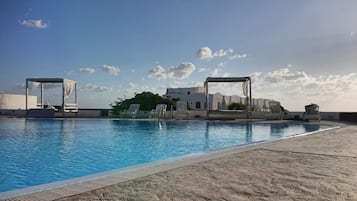 Seasonal outdoor pool, pool loungers