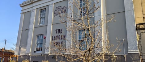 A building with a sign reading "The Linden Tree".
