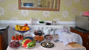 A breakfast buffet with various fruits, pastries, and beverages. - Holmlea Guest House (Blackpool)