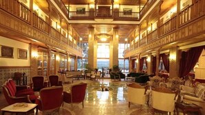 A spacious lobby with a high ceiling, wooden architecture, and multiple seating areas. - Kerme Ottoman Palace - Boutique Class (Ula)