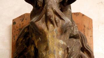 A bronze sculpture of a horse's head mounted on a wooden base.