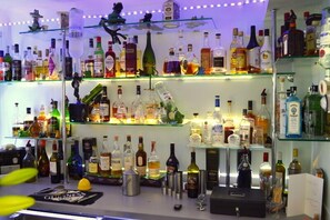A bar area with shelves stocked with various liquor bottles. - Watersedge Guest House (New Milton)
