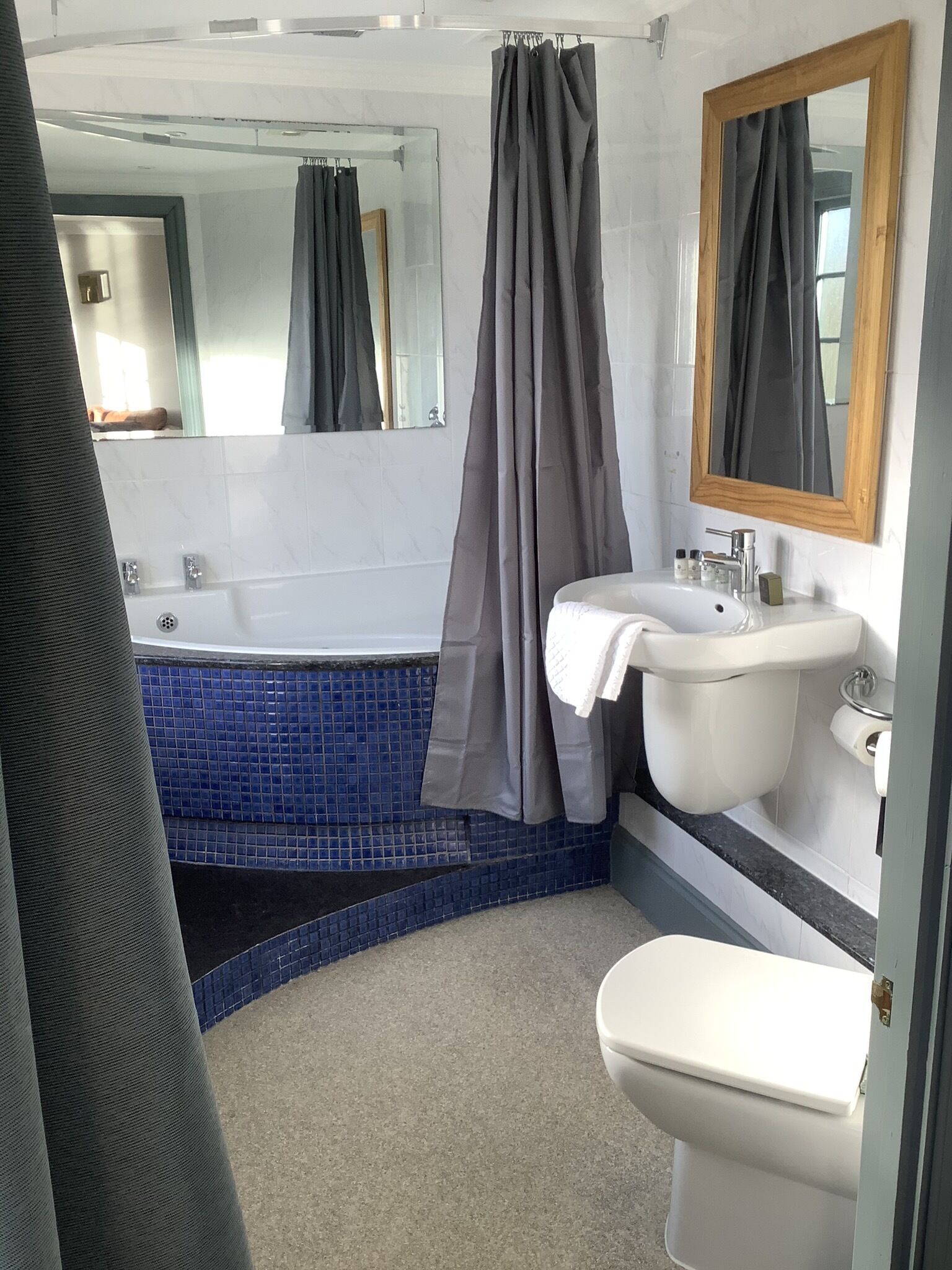 A bathroom with a bathtub, a sink, and a toilet.
