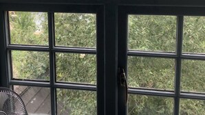 A greenhouse with a glass roof and a fan inside. - The Mooringpost (Gloucester)