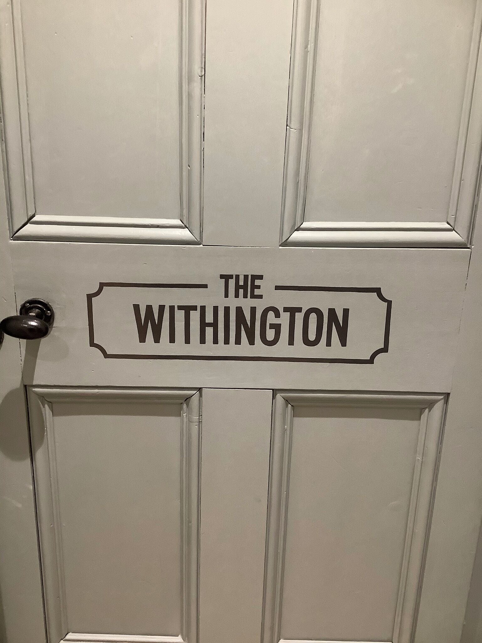 Una puerta con un letrero que dice THE WITHINGTON.