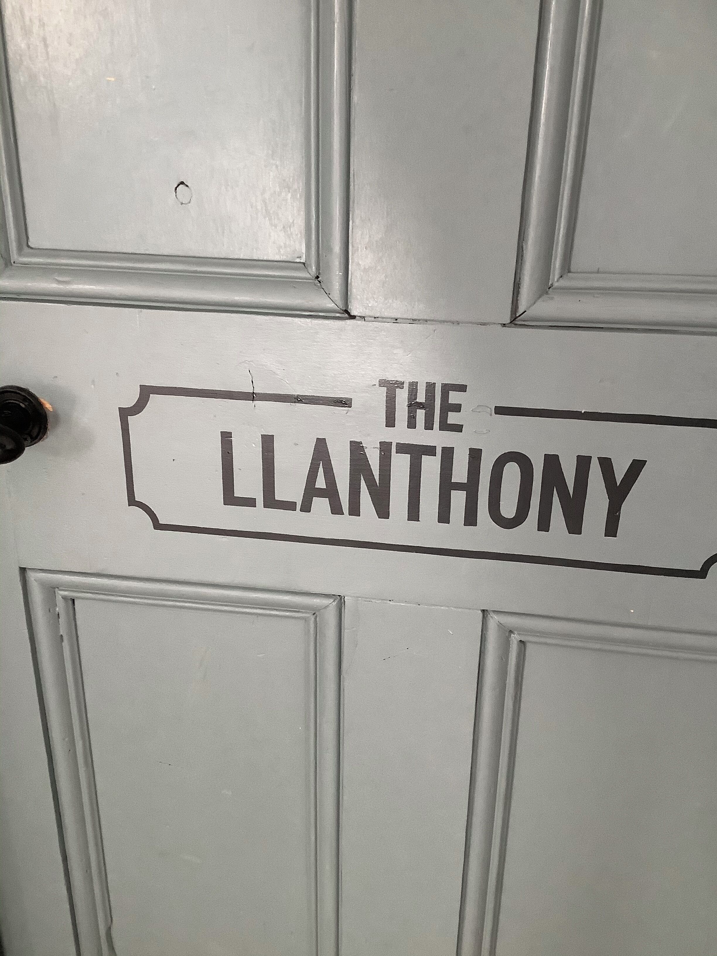 A door with the sign "THE LLANTONY" indicating the name of the establishment.