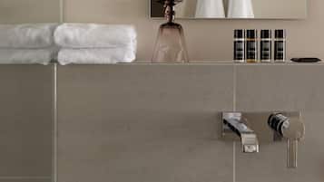 A bathroom with a white sink, a mirror, and a towel rack.