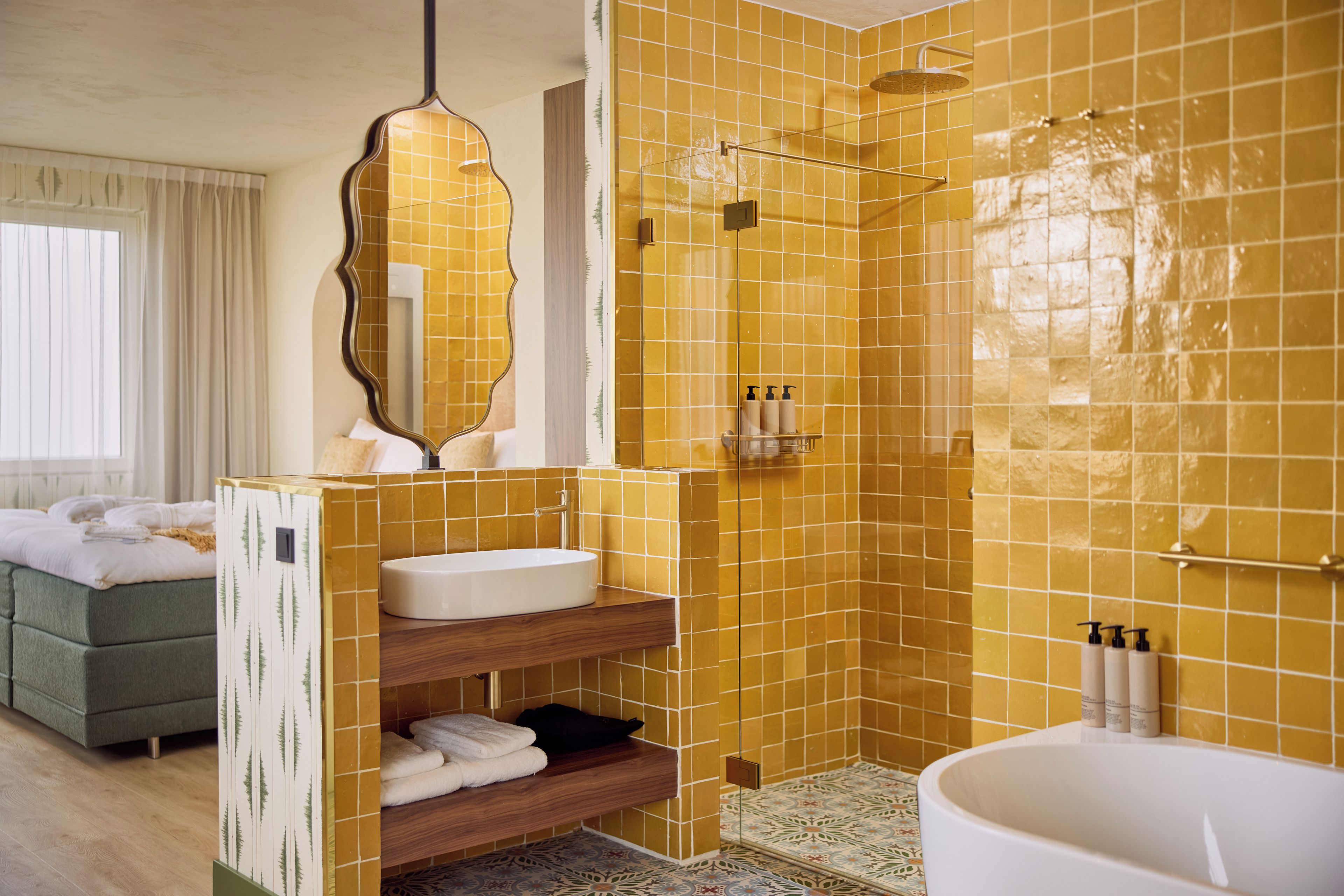 A bathroom with a shower, a sink, and a mirror.