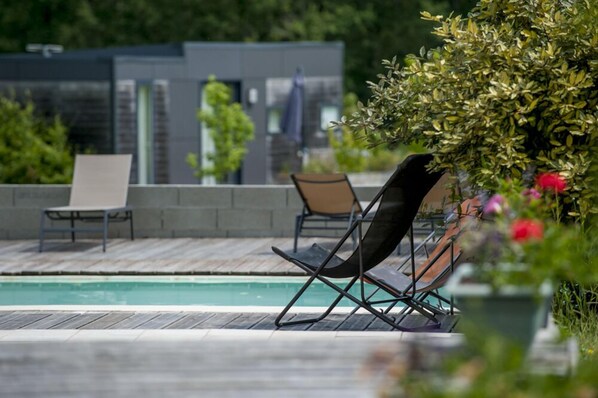 Seasonal outdoor pool, pool loungers