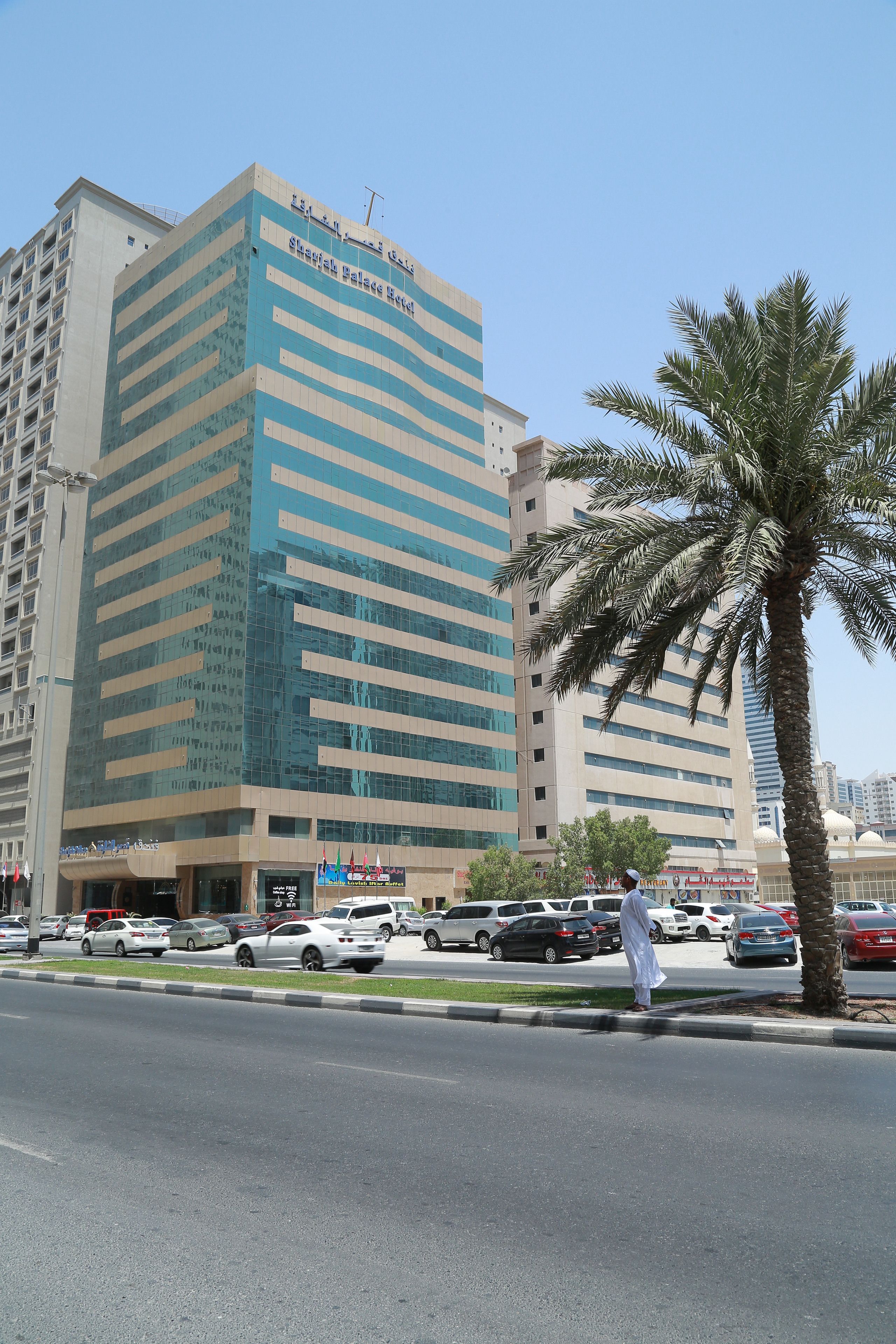 A multi-story building with a modern architectural design, featuring a prominent sign indicating it is a hospital.