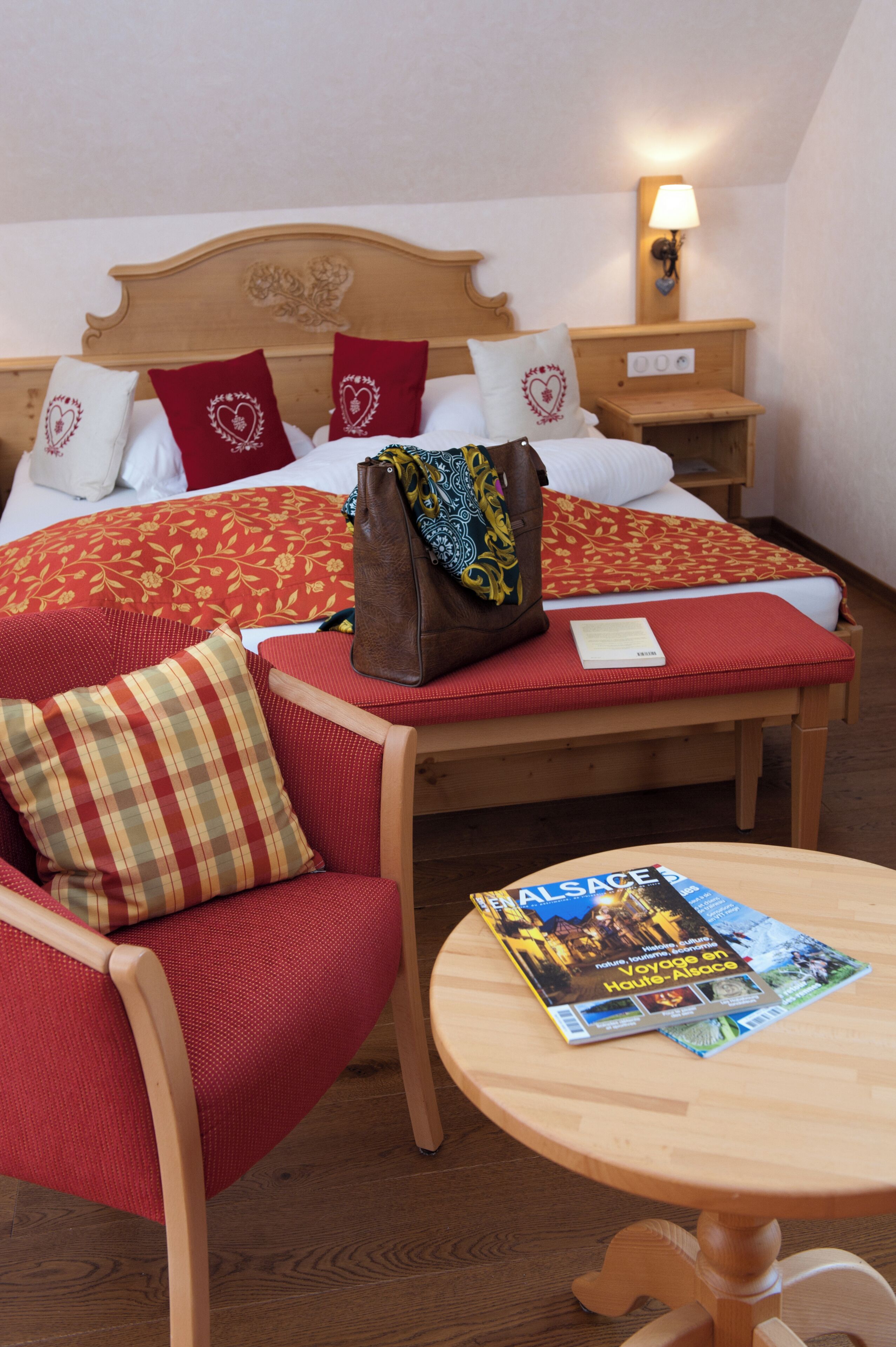 Een hotelkamer met een bed, een stoel, een tafel en een lamp.