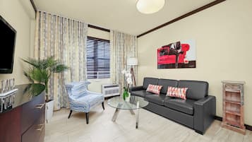 Two Bedroom Queen Suite | Living area | 42-inch plasma TV with cable channels, TV, iPod dock