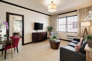 Two Bedroom Queen Suite | Living area | 42-inch plasma TV with cable channels, TV, iPod dock at Tradewinds Apartment Hotel