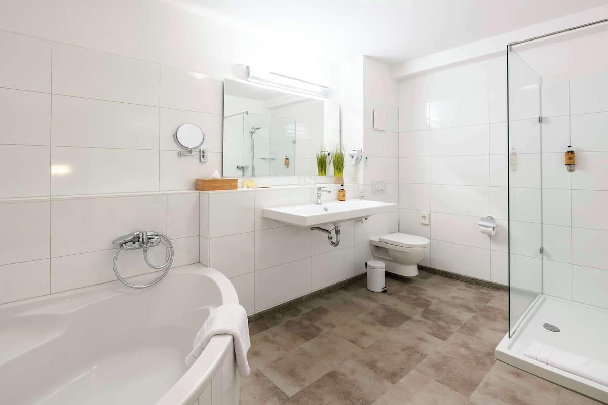 suite, 1 queen bed | bathroom | rainfall showerhead, free toiletries, hair dryer, towels