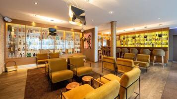 A bar area with multiple seating options, a well-stocked liquor display, and a modern interior design.
