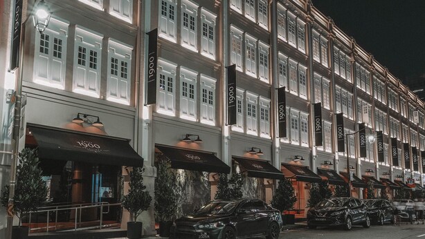 A row of hotel buildings with uniform facade and signage, featuring multiple windows and a consistent architectural style. - Hotel 1900 @ Chinatown (Singapore)