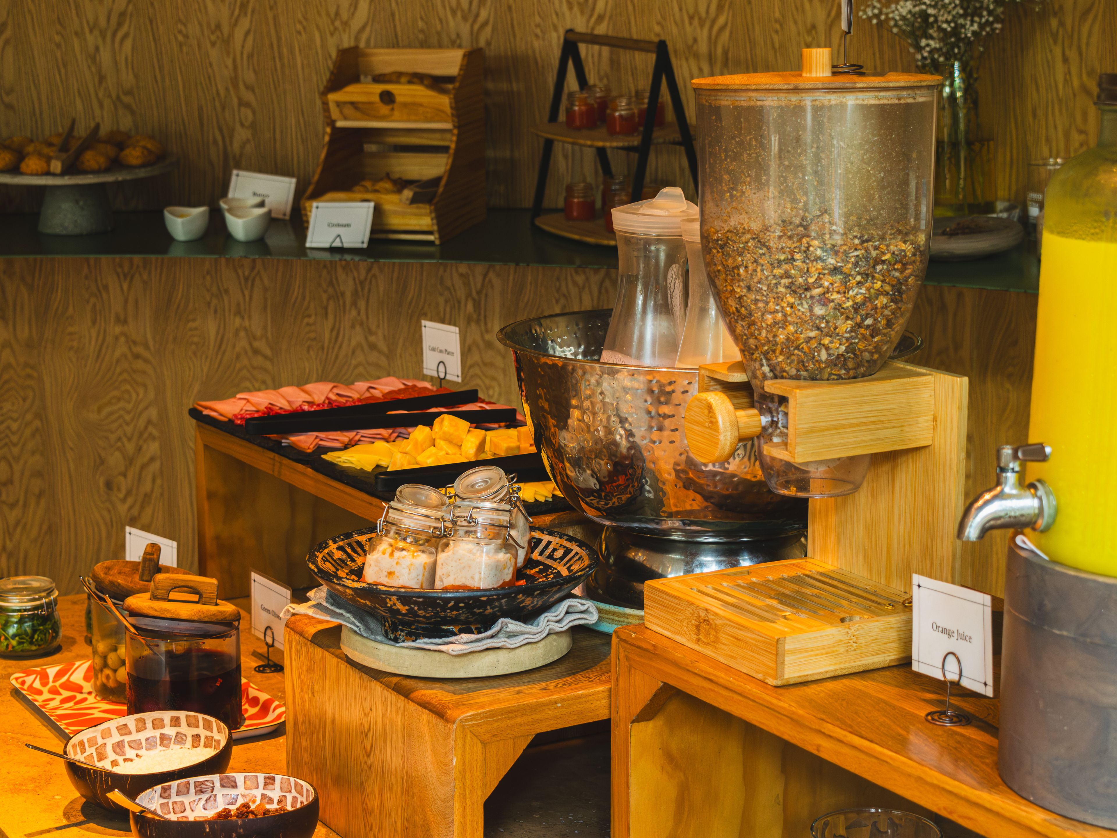 Montaje de bufé con diversas opciones de comida y una máquina de café.