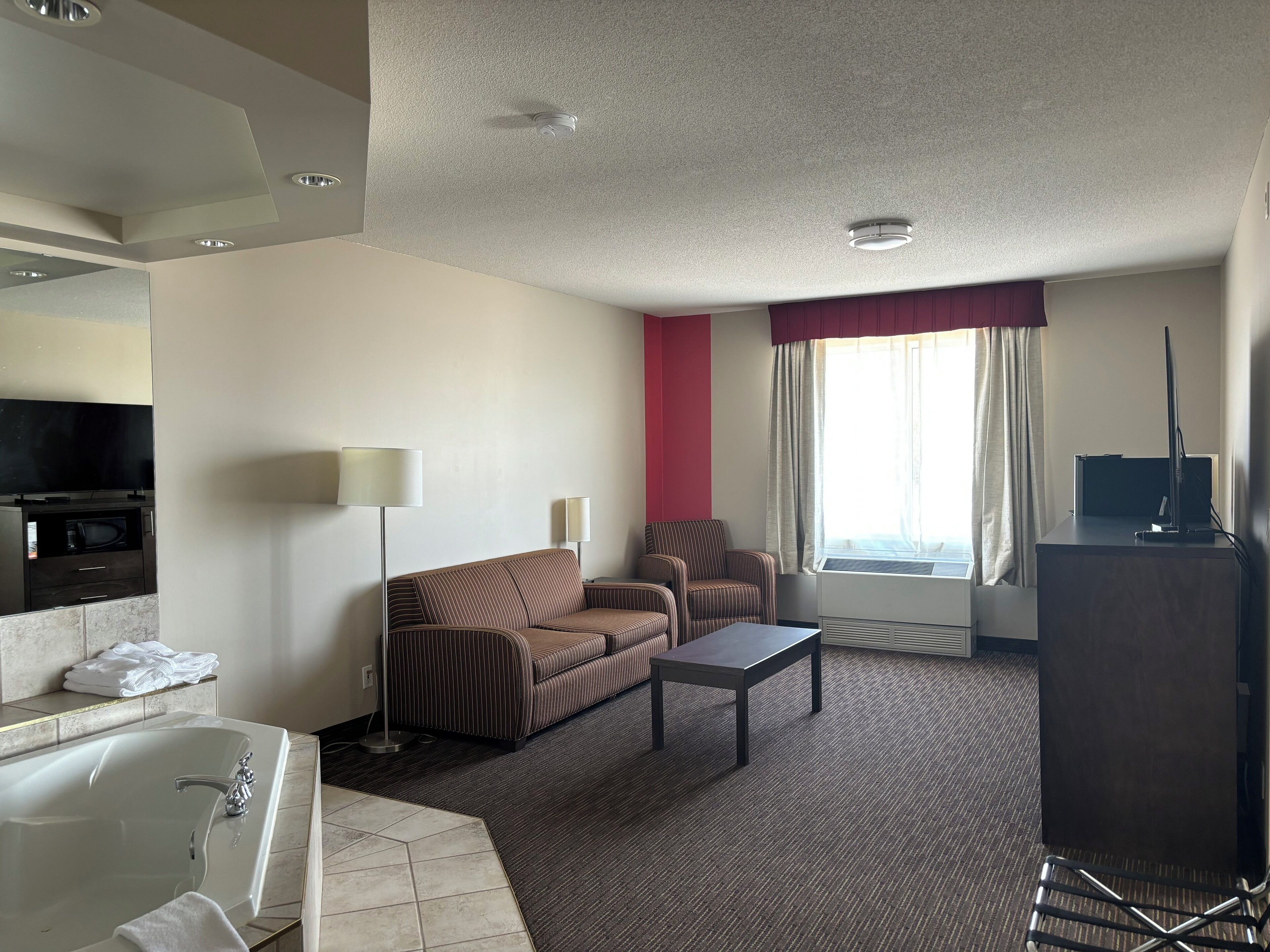 deluxe suite, 1 bedroom, non smoking (1 king bed) | bathroom | rainfall showerhead, free toiletries, hair dryer, towels