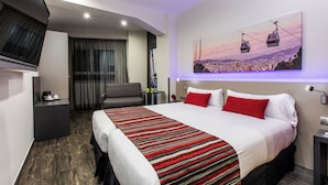 A modern hotel room with a large bed, a seating area, and a cityscape painting on the wall. - Leonardo Boutique Hotel Barcelona Sagrada Familia (Barcelona)